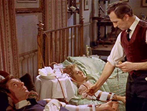 Van Helsing (Peter Cushing) gives Lucy (Carol Marsh) a blood transfusion with the help of Arthur (Michael Gough) in Hammer's Dracula (1958)