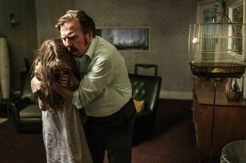Maurice Grosse (Timothy Spall) comforts Janet (Eleanor Worthington-Cox) in a scene from The Enfield Haunting