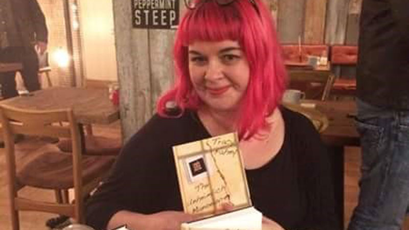Tracy Fahey with her book The Unheimlich Manoeurvre