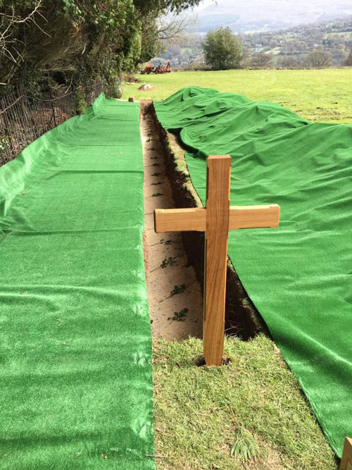 No longer forgotten - A row of red roses marked the final resting place. The funeral was attended by a few local villagers and overlooked by the rolling Welsh Mountains.