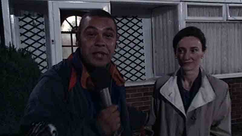 Craig Charles, reporting from the 'haunted' house, interviews Pamela Early (played by actress Brid Brennan) during Ghostwatch.