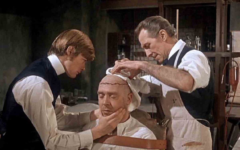 Simon Ward and Peter Cushing go to work on Freddie Jones in Frankenstein Must Be Destroyed 1969.