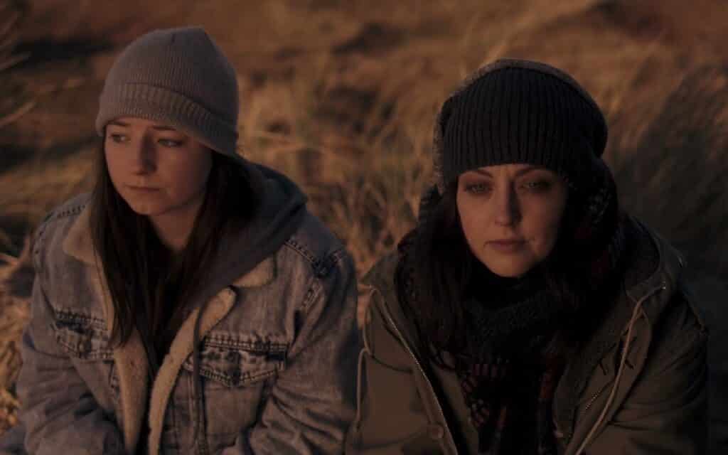 Hazel Doupe and Katherine Isabelle wait for sunrise in The Green Sea 2021