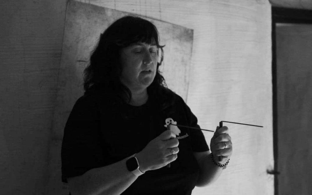 Rosemary Widdy Fahy, from Puca Paranormal, using her diving rods during an investigation.