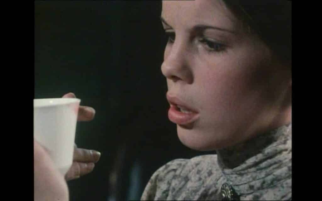 Florence (Lynne Miller) spots a mysterious lipstick stain in Haunted: Poor Girl (1974)