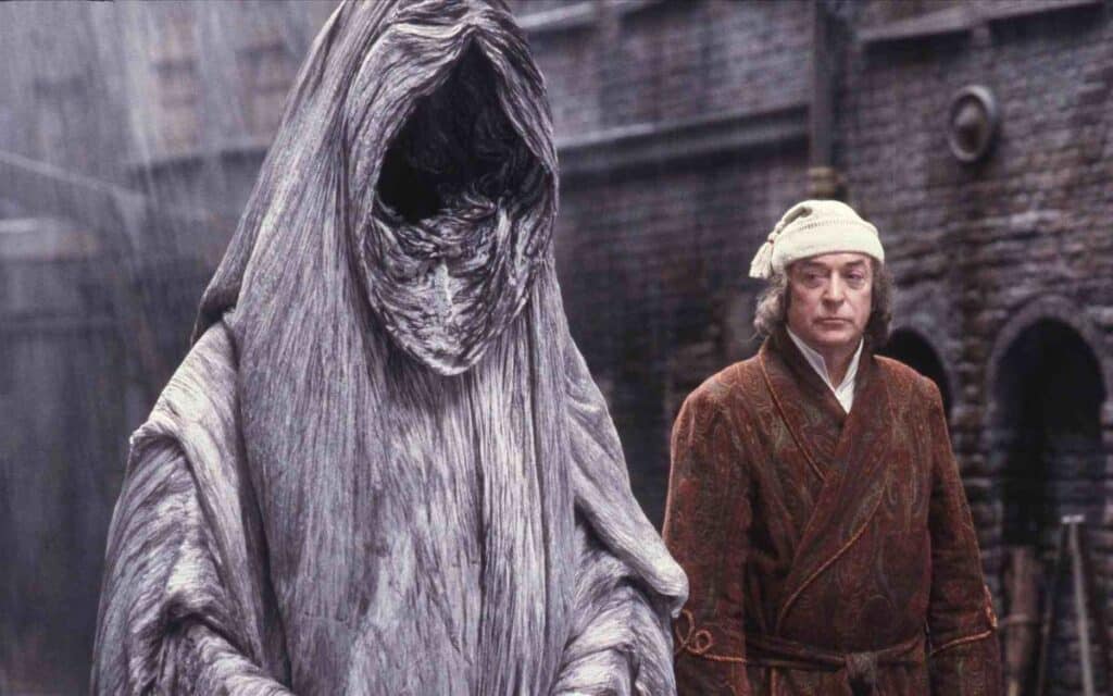 Scrooge (Michael Caine) with the Ghost of Christmas Yet To Come in A Muppet Christmas Carol 1992. 