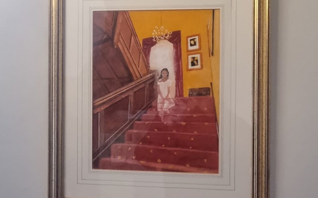 A painting of the ghost of Nell Hyde on the staircase at Hotel Celebrity in Bournemouth