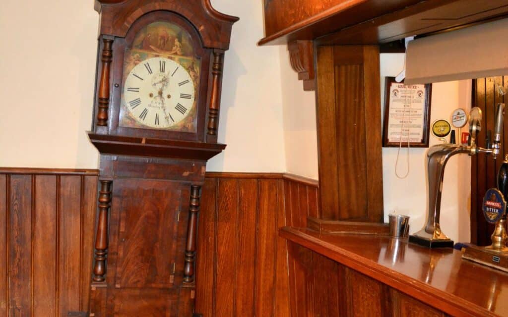 The Crooked House's seemingly crooked - but really quite vertical - grandfather clock. The clock's pendulum seemed to defy the laws of gravity!