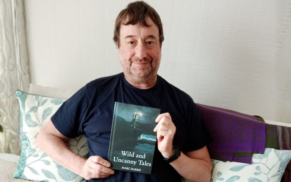 Marc Harris with his book, Wild and Uncanny Tales.