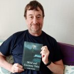 Marc Harris with his book, Wild and Uncanny Tales.