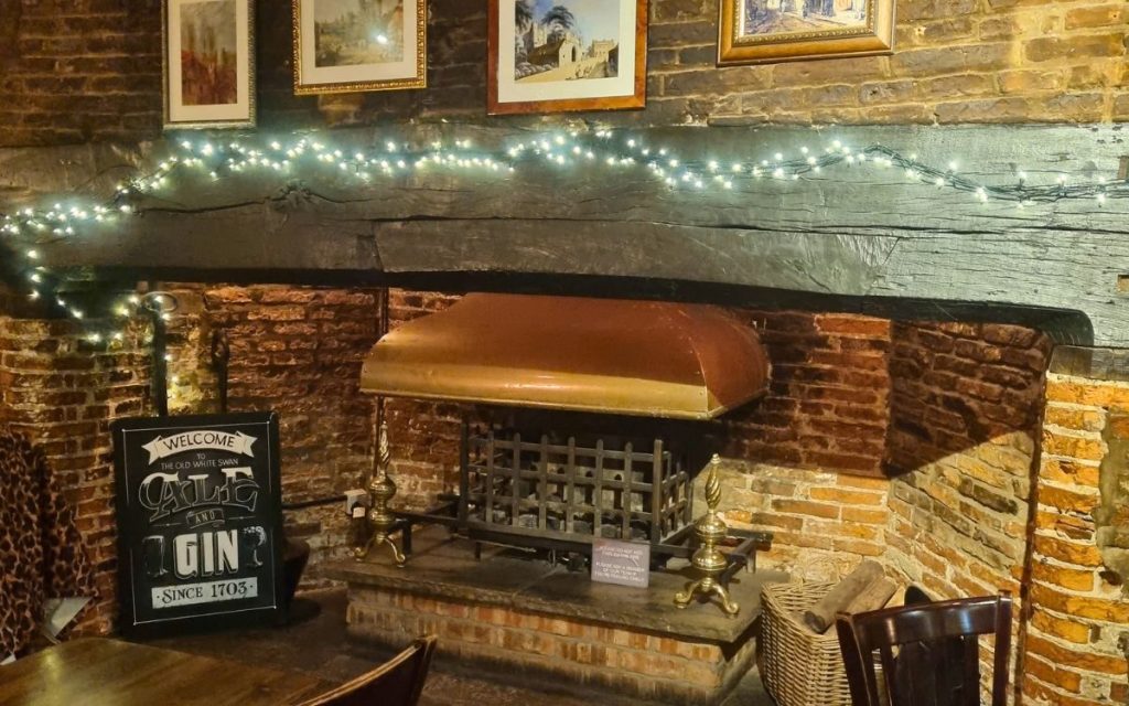 The fireplace at The Old White Swan, where figures are said to gather and relight the fire after it has gone out.