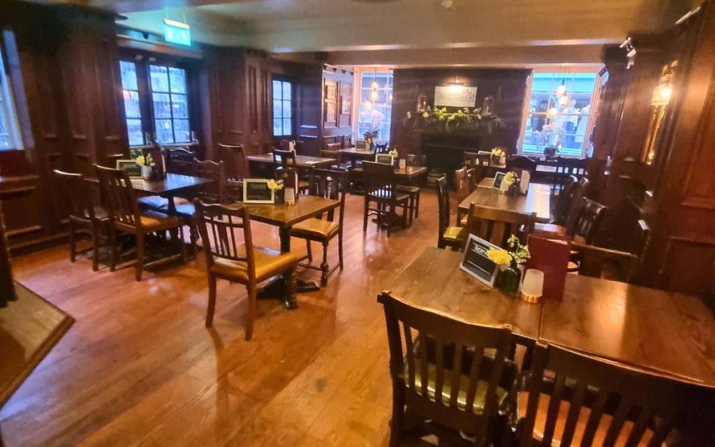 Inside The Old White Swan, dark wood and low beams give the pub its traditional, enclosed feel.