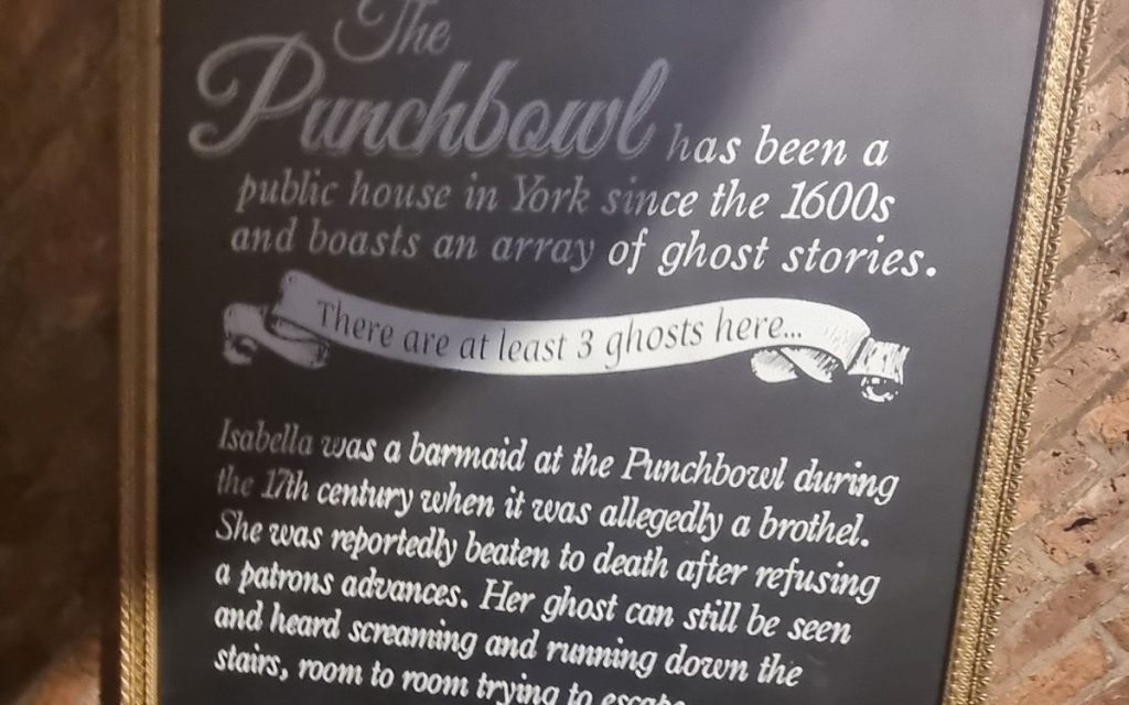Ghost stories sign inside The Punch Bowl York describing hauntings