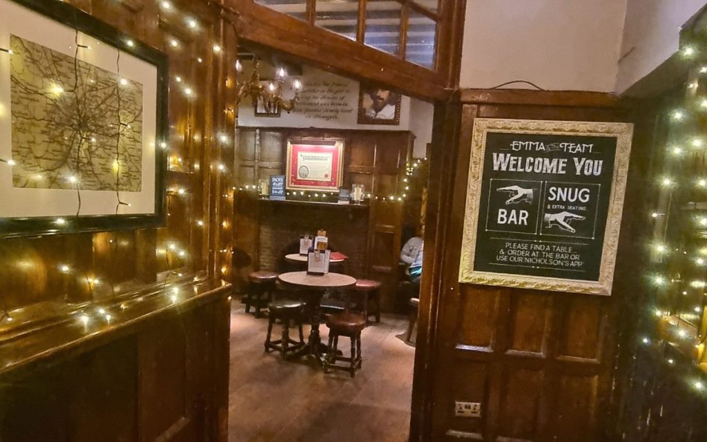 Interior of The Punch Bowl York wood panelled snug seating area