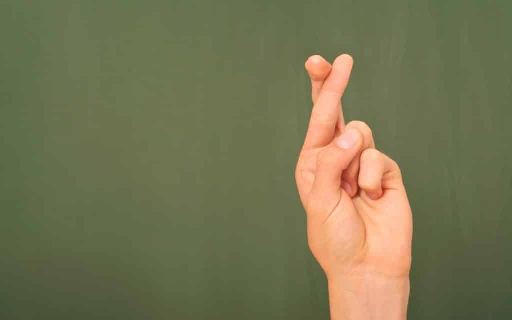 Why Do We Touch Wood? 10 Common Superstitions Explained 10 crossed fingers