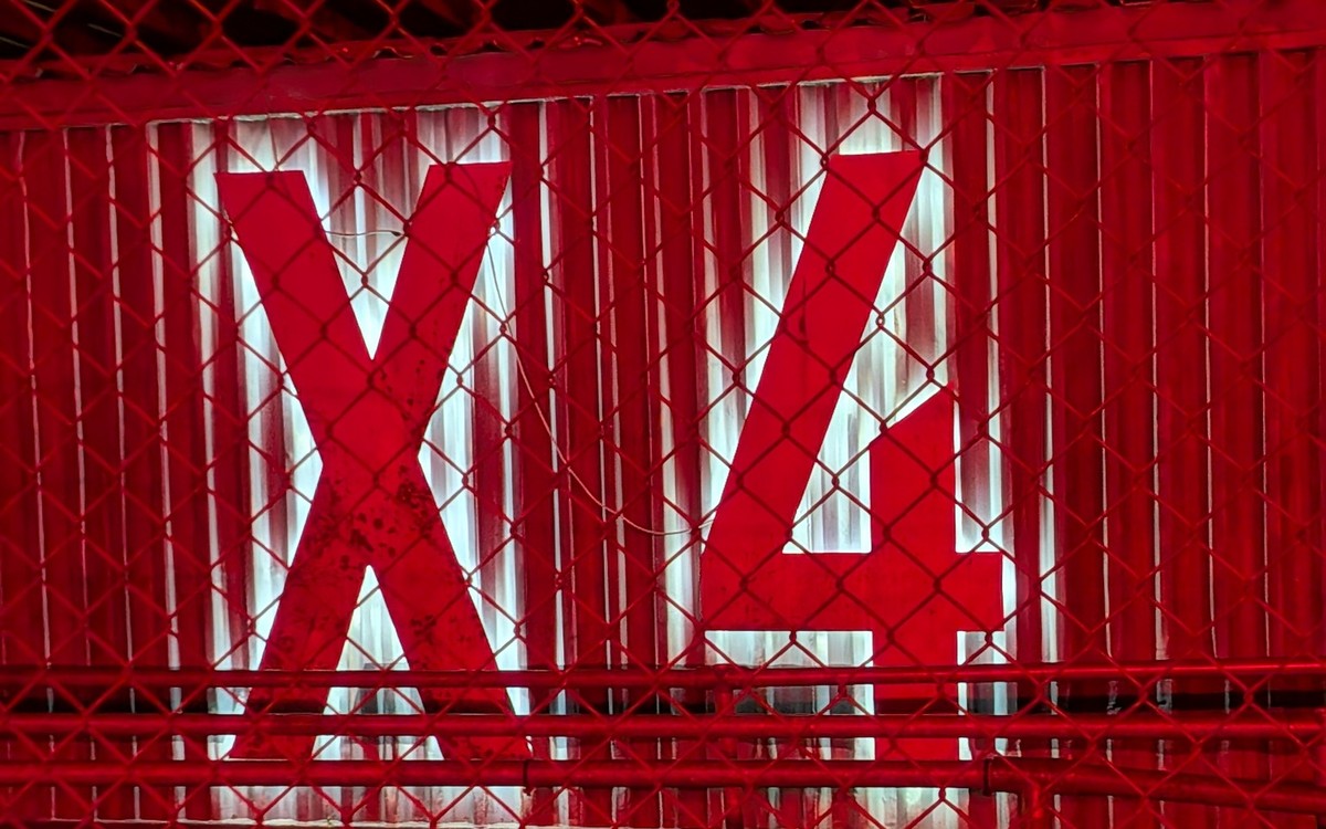 FEAR at Avon Valley 2026 REVIEW: braving Malefica alone 3 Large illuminated red X4 sign behind a chain-link fence at FEAR Scream Park.