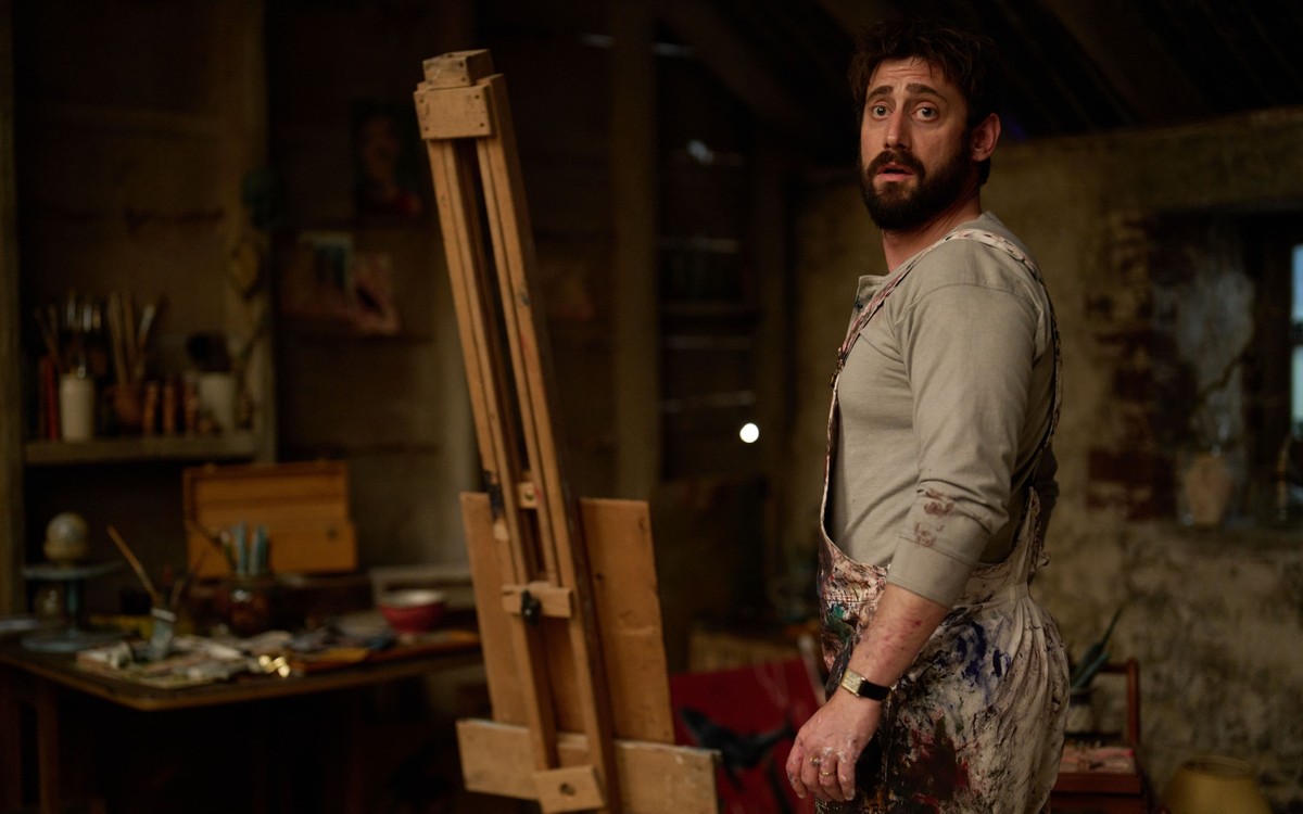BBC confirms The Witch Farm release date 7 Michael Socha as Bill turns away from an easel, wearing a paint-covered apron.