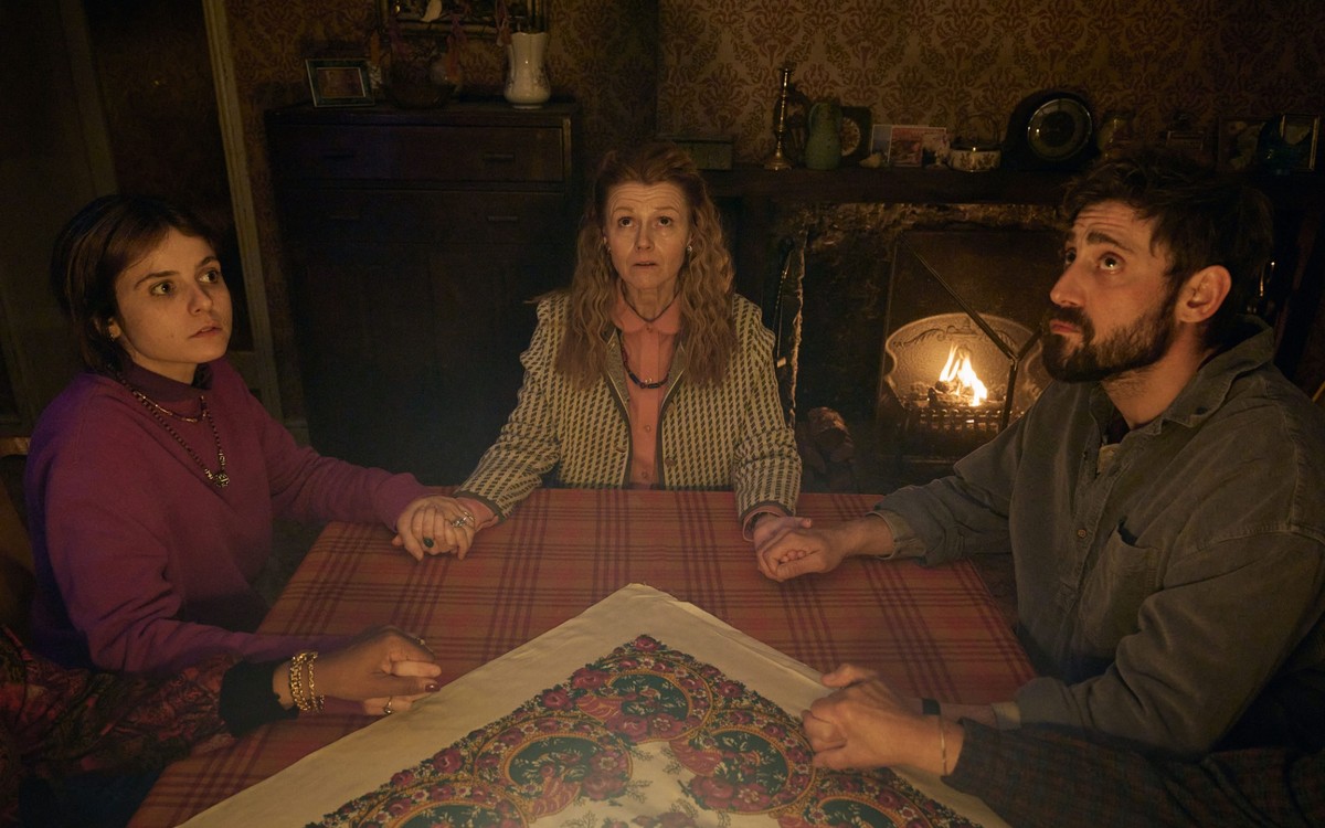 BBC confirms The Witch Farm release date 2 Liz, Bethan and Bill hold hands around a table and look upwards in The Witch Farm.